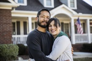 couple s'embrassant devant une maison