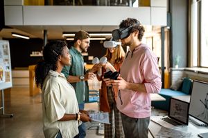 Personnes testant des casques AR pour jeux vidéo dans le bureau de l'entreprise