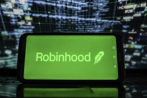 Logo Robinhood sur un smartphone avec des graphiques boursiers en arrière-plan